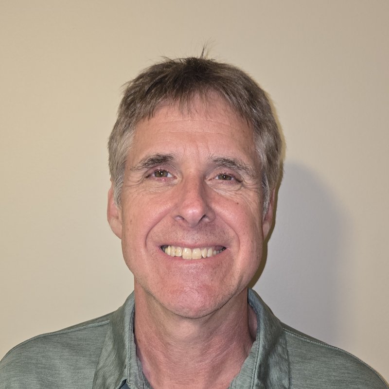 Rich Smith smiling in a casual green shirt